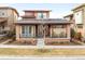 Charming home featuring a cozy front porch with rocking chairs and attractive architectural details at 89 Oneida St, Denver, CO 80230