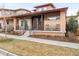 Charming home featuring a cozy front porch with rocking chairs and attractive architectural details at 89 Oneida St, Denver, CO 80230