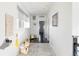 Bright hallway with dark hardwood floors, neutral colored rug, and natural lighting at 89 Oneida St, Denver, CO 80230
