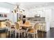 Open-concept dining and kitchen area features white cabinets, granite counters, and modern pendant lighting at 89 Oneida St, Denver, CO 80230