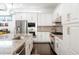 Bright kitchen features granite counters, stainless appliances, and sleek white cabinets at 89 Oneida St, Denver, CO 80230