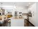 Spacious open kitchen includes granite counters, white cabinetry and stainless steel appliances next to dining area at 89 Oneida St, Denver, CO 80230
