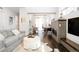 Comfortable living room featuring a fireplace, hardwood floors, and a cozy seating area at 89 Oneida St, Denver, CO 80230