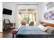 Spacious main bedroom includes outside patio access, stylish decor, and comfortable seating at 89 Oneida St, Denver, CO 80230
