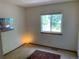 Bright bedroom with a large window offering natural light, complemented by a classic area rug at 11600 E Adriatic Pl, Aurora, CO 80014