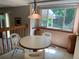 Bright breakfast nook with tile flooring, large windows with backyard views, and seating for three at 11600 E Adriatic Pl, Aurora, CO 80014