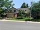 Charming two-story home with manicured lawn and mature trees providing ample shade and curb appeal at 11600 E Adriatic Pl, Aurora, CO 80014
