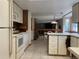 The kitchen features white appliances, tile floors, and a pass-through to the dining area at 11600 E Adriatic Pl, Aurora, CO 80014