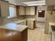 Well-lit kitchen with tile countertops and ample storage at 11600 E Adriatic Pl, Aurora, CO 80014