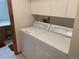 The laundry room features a full-sized washer and dryer plus storage cabinets at 11600 E Adriatic Pl, Aurora, CO 80014