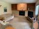 Carpeted living room with fireplace, built-in shelving, sofa, and sliding glass door at 11600 E Adriatic Pl, Aurora, CO 80014