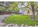Spacious backyard featuring a lush green lawn, wooden fence, mature trees and stone landscaping accents at 16200 Hedgeway Dr, Parker, CO 80134