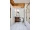Nicely tiled bathroom with a shower-tub combination, wood vanity, and wood panel ceiling at 16200 Hedgeway Dr, Parker, CO 80134