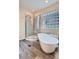 Bright bathroom featuring a glass shower and a freestanding tub with stylish fixtures at 16200 Hedgeway Dr, Parker, CO 80134