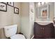 Cozy powder room featuring a modern vanity, decorative mirror, and charming wall decor at 16200 Hedgeway Dr, Parker, CO 80134