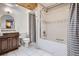 Well-lit bathroom with a shower-tub combination, wood vanity, and wood panel ceiling at 16200 Hedgeway Dr, Parker, CO 80134