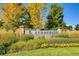 Stonegate community sign surrounded by colorful flowers and lush landscaping, set against a blue sky at 16200 Hedgeway Dr, Parker, CO 80134