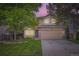 Charming two-story home with a well-manicured lawn, lush trees, and a welcoming two-car garage at 16200 Hedgeway Dr, Parker, CO 80134
