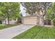 Charming two-story home with a well-maintained lawn, long driveway, and brick accents at 16200 Hedgeway Dr, Parker, CO 80134