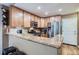 Bright, updated kitchen features stainless steel appliances, granite countertops, wood cabinets, and hardwood floors at 16200 Hedgeway Dr, Parker, CO 80134