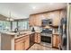 Well-lit kitchen featuring stainless steel appliances, light wood cabinetry and granite countertops at 16200 Hedgeway Dr, Parker, CO 80134