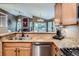 Open concept kitchen features stainless steel appliances, granite countertops, wood cabinets, and hardwood floors at 16200 Hedgeway Dr, Parker, CO 80134