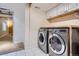Bright laundry room with front load washer and dryer and storage cabinets at 16200 Hedgeway Dr, Parker, CO 80134