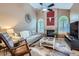 Bright living room with a cozy fireplace, large windows, and a comfortable seating arrangement at 16200 Hedgeway Dr, Parker, CO 80134