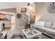 Spacious living area with open floor plan, seamless transition to the kitchen, and modern staircase at 16200 Hedgeway Dr, Parker, CO 80134