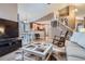 Open-concept living area flowing into a modern kitchen with a breakfast bar and stainless steel appliances at 16200 Hedgeway Dr, Parker, CO 80134