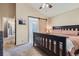 Serene main bedroom with sliding barn door to ensuite bath, plush carpet, and a calming color palette at 16200 Hedgeway Dr, Parker, CO 80134