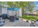Patio and backyard with outdoor dining under the umbrella and grill for outdoor cooking and fenced yard at 1153 Berganot Trl, Castle Pines, CO 80108