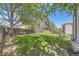 A spacious, grassy backyard with mature trees, privacy fence, a stone terrace and well-maintained lawn at 1153 Berganot Trl, Castle Pines, CO 80108