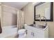 Bathroom features a modern sink and vanity, tub and shower combo with tile and a framed mirror at 1153 Berganot Trl, Castle Pines, CO 80108
