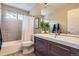 Updated bathroom featuring a modern vanity with a large mirror, a bathtub with shower and tiled walls at 1153 Berganot Trl, Castle Pines, CO 80108