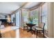 Cozy breakfast nook with bay windows, wood floors, and charming decor with view of the fireplace at 1153 Berganot Trl, Castle Pines, CO 80108