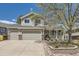 Charming two-story home with a well-manicured lawn, a three-car garage and a cozy front porch at 1153 Berganot Trl, Castle Pines, CO 80108
