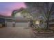 Charming two-story home featuring a large front yard, attached two-car garage, and welcoming front porch at 1153 Berganot Trl, Castle Pines, CO 80108
