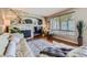 Inviting living room features a stone fireplace, large windows, and comfortable seating creating a warm and welcoming atmosphere at 1153 Berganot Trl, Castle Pines, CO 80108