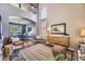 Elegant living room with high ceilings, hardwood floors, stylish decor, and an adjacent dining area at 1153 Berganot Trl, Castle Pines, CO 80108
