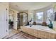 Well-appointed primary bathroom with a soaking tub, glass-enclosed shower, and modern fixtures, creating a spa-like experience at 1153 Berganot Trl, Castle Pines, CO 80108