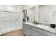 Bright bathroom featuring double sinks with granite counters, walk-in shower and modern finishes at 4692 Hatcher Dr, Brighton, CO 80601