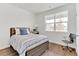 Bedroom with light walls, a large window, and wood-look floors offering a comfortable retreat at 4692 Hatcher Dr, Brighton, CO 80601