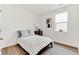 Comfortable bedroom with a full-sized bed, wood flooring, and natural light from a window at 4692 Hatcher Dr, Brighton, CO 80601