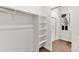Walk-in closet leading to a bathroom with a glass-enclosed shower and modern finishes at 4692 Hatcher Dr, Brighton, CO 80601