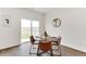 Cozy dining area with a round table, seating for four, and a sliding glass door at 4692 Hatcher Dr, Brighton, CO 80601
