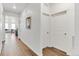 Bright hallway with hardwood floors and fresh white paint leading to the living area at 4692 Hatcher Dr, Brighton, CO 80601