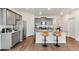 Modern kitchen featuring gray cabinets, granite counters, stainless appliances, and bar stool seating at 4692 Hatcher Dr, Brighton, CO 80601