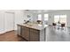 Open-concept kitchen with an island, stainless steel appliances, and view of the dining and living areas at 4692 Hatcher Dr, Brighton, CO 80601