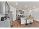 Well-lit kitchen featuring gray cabinets, an island with bar seating, and stainless steel appliances at 4692 Hatcher Dr, Brighton, CO 80601